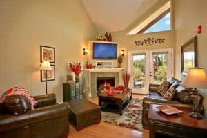 A beautiful living room with a fireplace in one of the rentals from Appleview River Resort in the Smoky Mountains.