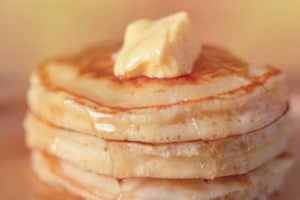 stack of pancakes with syrup and butter