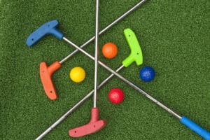 miniature golf clubs and balls of all colors